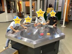 エアーホッケーで遊ぶ子どもたち