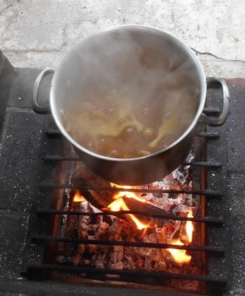 カレーがたき火の上で湯気を立てて出来上がったところ